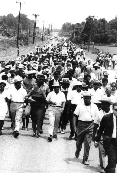 A group of people marching down a road.
