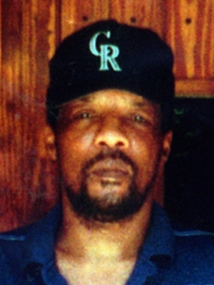 A photo of a man wearing a black baseball cap with "CR" and a blue polo shirt.