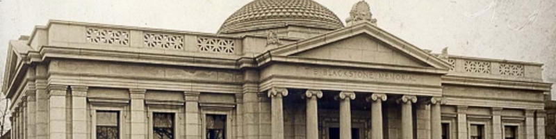 Exterior photo of the Blackstone Library. The building is white marble with a teal dome at the top, and columns in front.