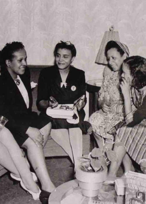 A group of Black adults meet in a Chicago living room to plan a march on Washington in 1940.